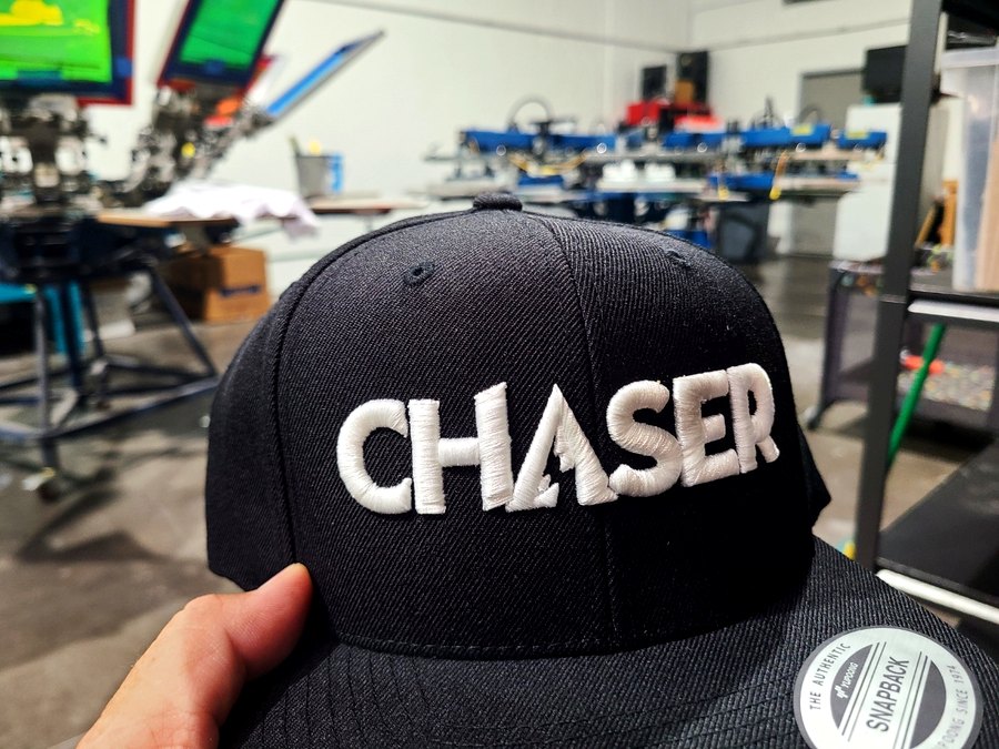 Chaser embroidered snapback hat fresh off the machine at Russell's Print Shop