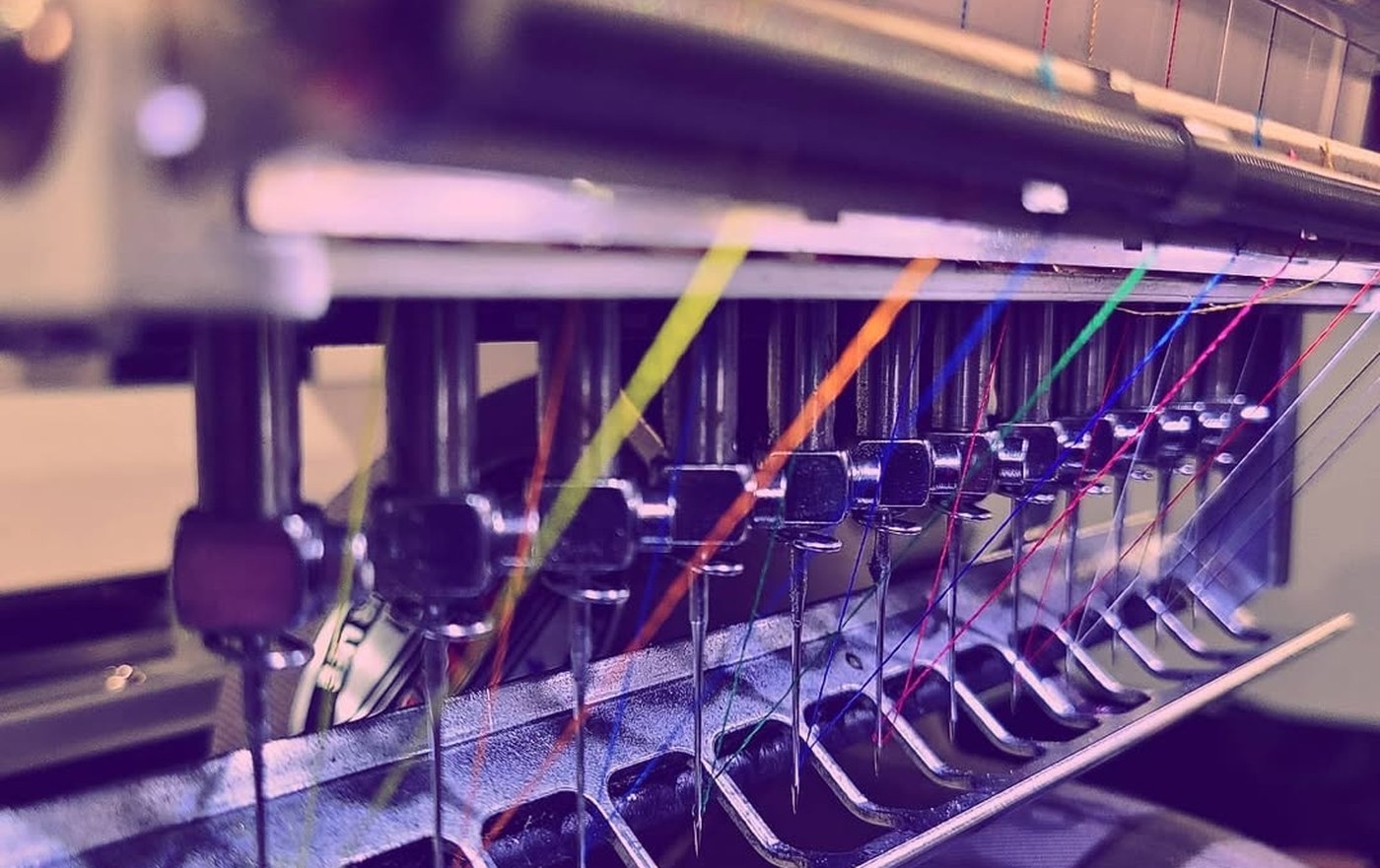 Embroidery machine needles and colored threads at Russell's Print Shop